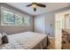 Cozy bedroom featuring a ceiling fan, light-filled windows, and a neutral color palette at 6338 S Oneida Ct, Centennial, CO 80111