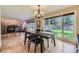 Bright dining room with wood floors and a view of the spacious backyard through large windows at 6338 S Oneida Ct, Centennial, CO 80111