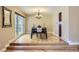 Dining area showcasing natural light, chandelier, and hardwood floors that lead to the kitchen at 6338 S Oneida Ct, Centennial, CO 80111