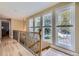 Bright hallway with hardwood floors and three large windows offering neighborhood views at 6338 S Oneida Ct, Centennial, CO 80111