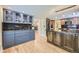 Spacious kitchen with stainless steel appliances, glass-front cabinets, and hardwood floors at 6338 S Oneida Ct, Centennial, CO 80111