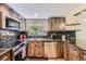Well-equipped kitchen with granite counters, stainless steel appliances, and ample counter space at 6338 S Oneida Ct, Centennial, CO 80111