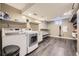 Well-organized laundry room equipped with modern washer, dryer, and built-in shelving at 6338 S Oneida Ct, Centennial, CO 80111