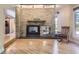 Bright and spacious living area with a stone fireplace, hardwood floors, and natural light at 6338 S Oneida Ct, Centennial, CO 80111