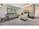 Comfortable living area with a stone fireplace and sliding glass doors at 6338 S Oneida Ct, Centennial, CO 80111