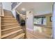 Inviting staircase with hardwood steps and iron railings leading to a spacious living area at 6338 S Oneida Ct, Centennial, CO 80111