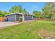 Spacious backyard featuring a well-kept lawn, partial fence, and patio area at 2598 Teller St, Lakewood, CO 80214