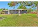Large backyard with a well-maintained lawn, mature trees, and privacy fence at 2598 Teller St, Lakewood, CO 80214