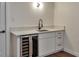 The bar area features a sleek countertop, modern sink, and convenient wine fridge at 2598 Teller St, Lakewood, CO 80214