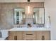 Bathroom vanity featuring a double sink, designer mirrors, and modern fixtures at 2598 Teller St, Lakewood, CO 80214