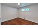 This empty bedroom features hardwood floors, a window, and white walls at 2598 Teller St, Lakewood, CO 80214