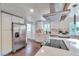 Spacious kitchen with a stainless steel refrigerator, white cabinets, and stylish countertops at 2598 Teller St, Lakewood, CO 80214