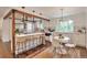 Modern kitchen features an island with bar seating and an adjacent dining area with natural light at 2598 Teller St, Lakewood, CO 80214