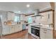 Bright kitchen with stainless steel appliances, wooden beams, and plenty of counter space at 2598 Teller St, Lakewood, CO 80214
