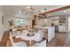 Open floor plan connecting the living room, kitchen, and dining area, ideal for entertaining at 2598 Teller St, Lakewood, CO 80214