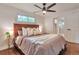 Bedroom with a wooden headboard, large window, and a modern ceiling fan at 2598 Teller St, Lakewood, CO 80214