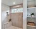 Contemporary shower with a rainfall shower head, bench, and built-in shelving at 2598 Teller St, Lakewood, CO 80214