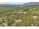 Aerial view of the wooded neighborhood with a red arrow indicating the home's location at 29433 Firethorne Ct, Evergreen, CO 80439