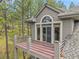 Exterior view showing the home's second story private balcony with gray wood and metal railing at 29433 Firethorne Ct, Evergreen, CO 80439