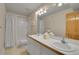 Bathroom with double sinks, tile floors, and shower with curtain at 29433 Firethorne Ct, Evergreen, CO 80439
