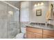 Bathroom with a granite vanity, walk-in shower, and a window with natural light at 29433 Firethorne Ct, Evergreen, CO 80439