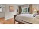 Comfortable bedroom with hardwood floors and a large window with forest views at 29433 Firethorne Ct, Evergreen, CO 80439
