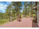 Expansive deck overlooking lush greenery provides an inviting outdoor space for relaxation and entertainment at 29433 Firethorne Ct, Evergreen, CO 80439