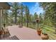Relaxing deck surrounded by lush trees provides a serene outdoor retreat and connection with nature at 29433 Firethorne Ct, Evergreen, CO 80439