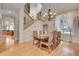 Elegant dining room with hardwood floors, wainscoting, and a chandelier at 29433 Firethorne Ct, Evergreen, CO 80439