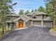 Stunning two-story home with a three-car garage, stone accents, and a paved driveway at 29433 Firethorne Ct, Evergreen, CO 80439