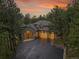 Exterior dusk shot featuring garage and beautiful stonework at 29433 Firethorne Ct, Evergreen, CO 80439