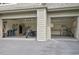 Large garage with a motorcycle parked, ample storage space, and a workbench at 29433 Firethorne Ct, Evergreen, CO 80439