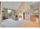 Bright living room with fireplace, large windows, and view at 29433 Firethorne Ct, Evergreen, CO 80439