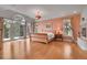 Bright main bedroom with a fireplace, access to a private balcony, and hardwood floors at 29433 Firethorne Ct, Evergreen, CO 80439
