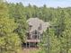 Beautiful home surrounded by a dense forest of evergreen trees at 29433 Firethorne Ct, Evergreen, CO 80439