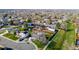 Suburban neighborhood showcases charming homes with well-maintained yards, solar panels, and a lush green space running through the community at 4465 E 121St Pl, Thornton, CO 80241