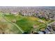 Areal view of neighborhood near a huge green space with walking paths, a school and green space at 4465 E 121St Pl, Thornton, CO 80241