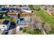 Aerial view of a home with solar panels, a well-kept lawn, mature trees, and a long driveway at 4465 E 121St Pl, Thornton, CO 80241
