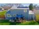 Two-story home boasts a backyard with a deck, solar panels, a well-maintained lawn, and outdoor seating at 4465 E 121St Pl, Thornton, CO 80241