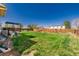 Spacious backyard featuring a lush lawn, mature trees, and a wooden fence at 4465 E 121St Pl, Thornton, CO 80241