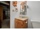 Compact bathroom with a sink, toilet, and medicine cabinet at 4465 E 121St Pl, Thornton, CO 80241