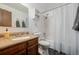 Bathroom with a wood vanity, tile flooring, and shower-tub combo at 4465 E 121St Pl, Thornton, CO 80241