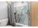 This bathroom features a shower with stone-look tile surround, a shower seat, and a hand-held shower head at 4465 E 121St Pl, Thornton, CO 80241