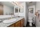 Well-lit bathroom featuring a granite countertop, wood cabinets, and a modern toilet at 4465 E 121St Pl, Thornton, CO 80241