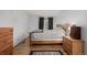 Well-lit bedroom with natural wood flooring, light-colored walls, and a cozy rug at 4465 E 121St Pl, Thornton, CO 80241