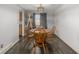 Cozy dining room with wood table, wooden chairs, modern lighting, and wood-look flooring at 4465 E 121St Pl, Thornton, CO 80241