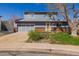 Charming two-story home featuring a well-maintained front yard, attached garage, and sunny yellow front door at 4465 E 121St Pl, Thornton, CO 80241