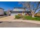 Charming two-story home with a well-manicured front lawn, attached garage, and a sunny yellow front door at 4465 E 121St Pl, Thornton, CO 80241