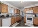 Bright kitchen featuring wood cabinets, granite countertops, and modern white appliances at 4465 E 121St Pl, Thornton, CO 80241