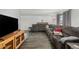 Spacious living room featuring a large sectional sofa and hardwood floors at 4465 E 121St Pl, Thornton, CO 80241